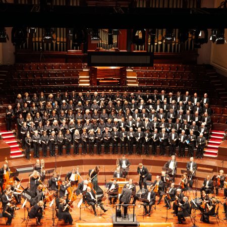 A majestic orchestra and choir performing at a historic venue in Edinburgh, Scotland.